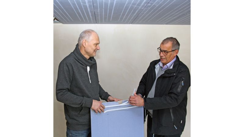 Foto: Bauherr und Technischer Berater besprechen die Installation des Trockenbausystems „Renovis“ zur Deckenheizung und -kühlung.