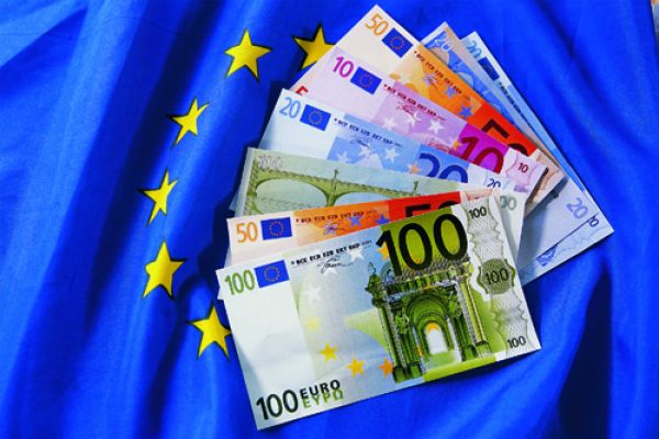 Das Bild zeigt Geld auf einer EU-Flagge.